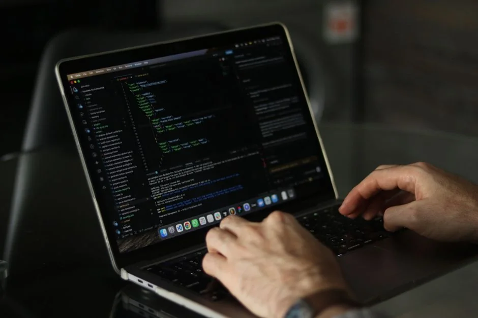 A bright modern office setup with computers and a mug on a desk.